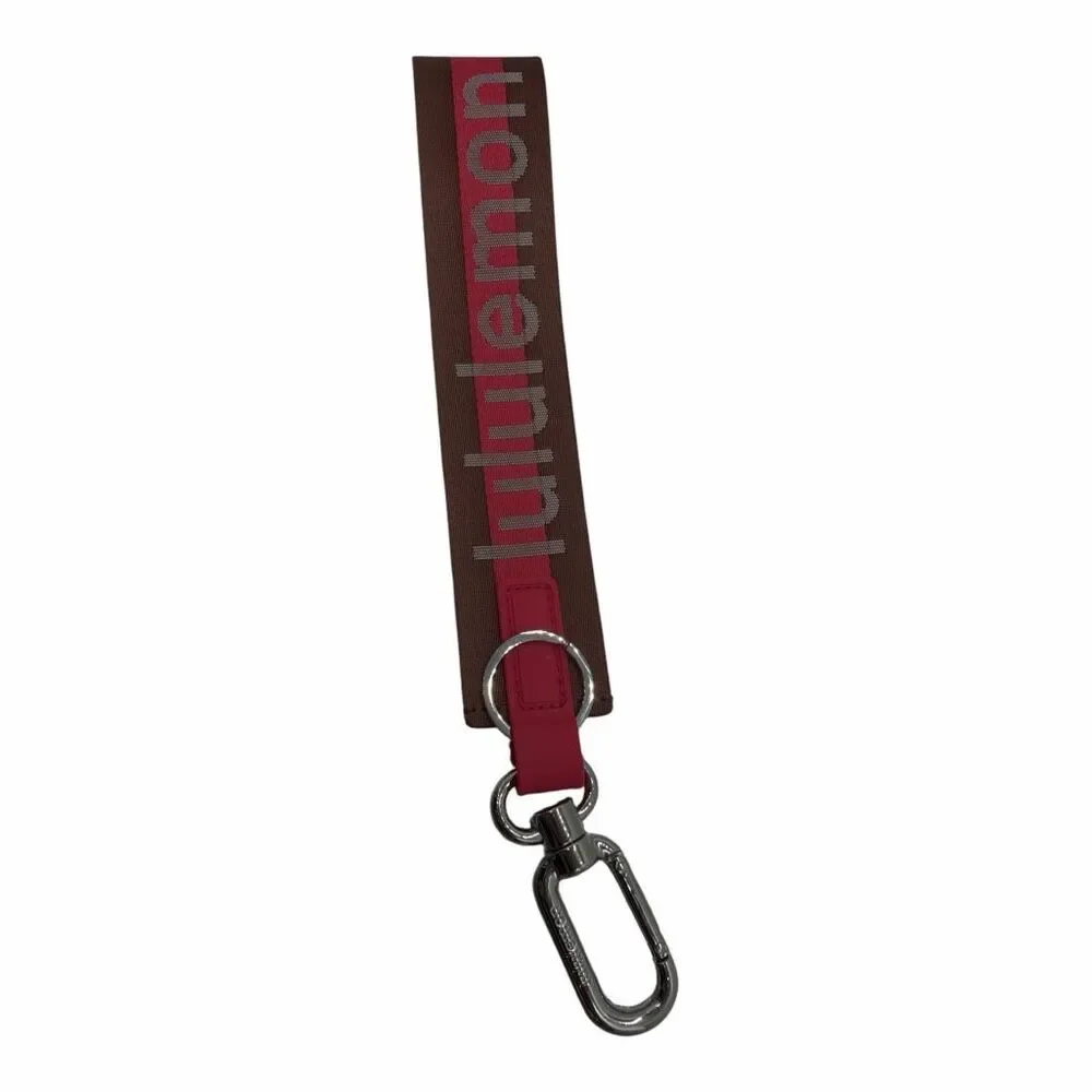 NWOT LULULEMON NEVER LOST KEYCHAIN WORDMARK PINK AND BROWN COLOR ONE SIZE